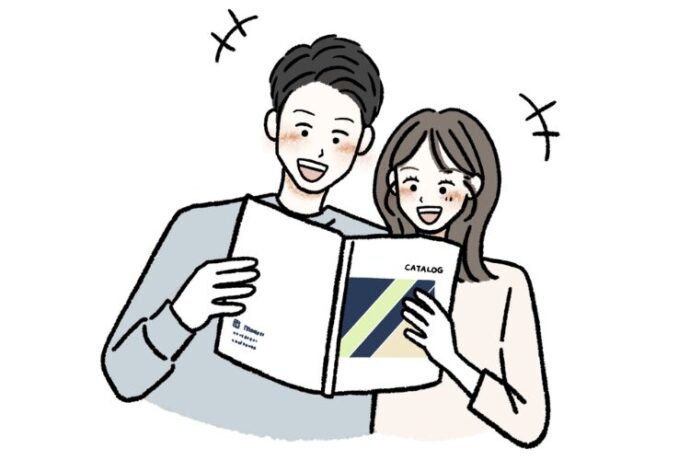 カタログを見ながら話すカップルのイラスト画像