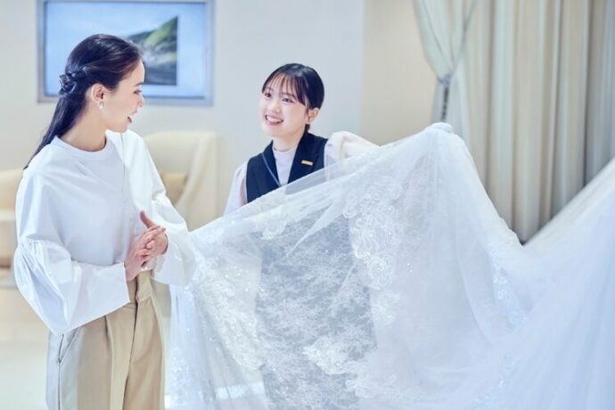 担当スタッフからドレスの説明を受ける女性の様子
